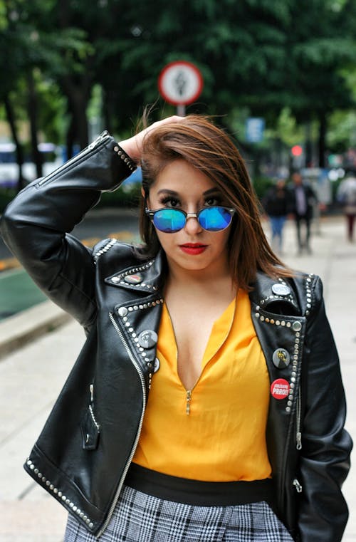 Portrait of a Pretty Brunette Wearing Sunglasses and a Leather Jacket