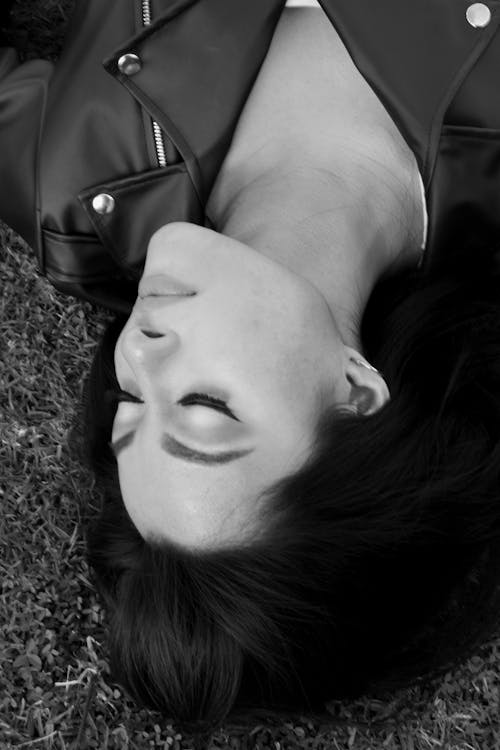 Black and White Upside Down Portrait of a Woman Lying Down on a Ground
