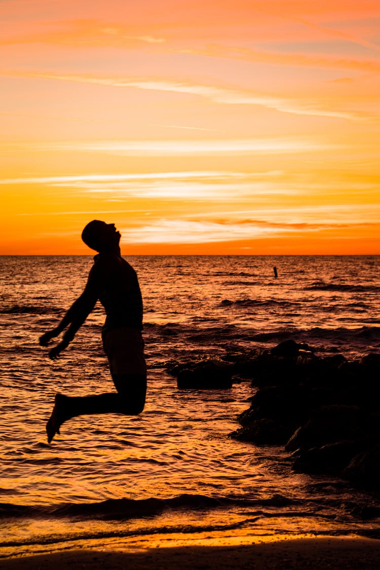 Man Jumping On Sea