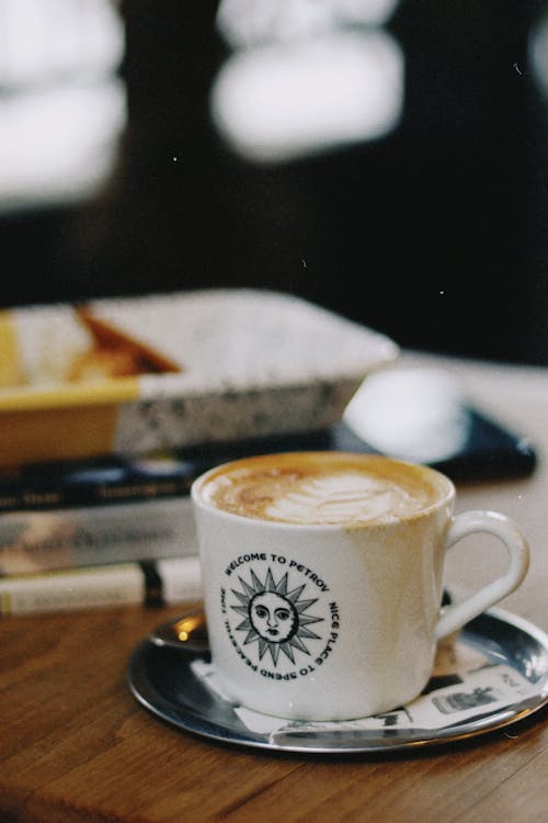 Free Close-up of a Coffee with Latte Art on a Table in a Cafe  Stock Photo