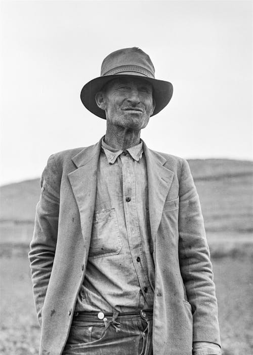 Grayscale Portrait of a Man in Suit Jacket and Panama Hat