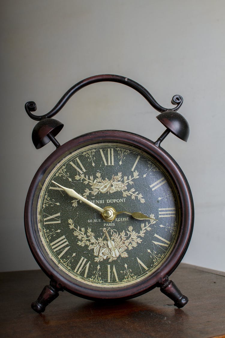 Brown Framed Alarm Clock On Brown Table