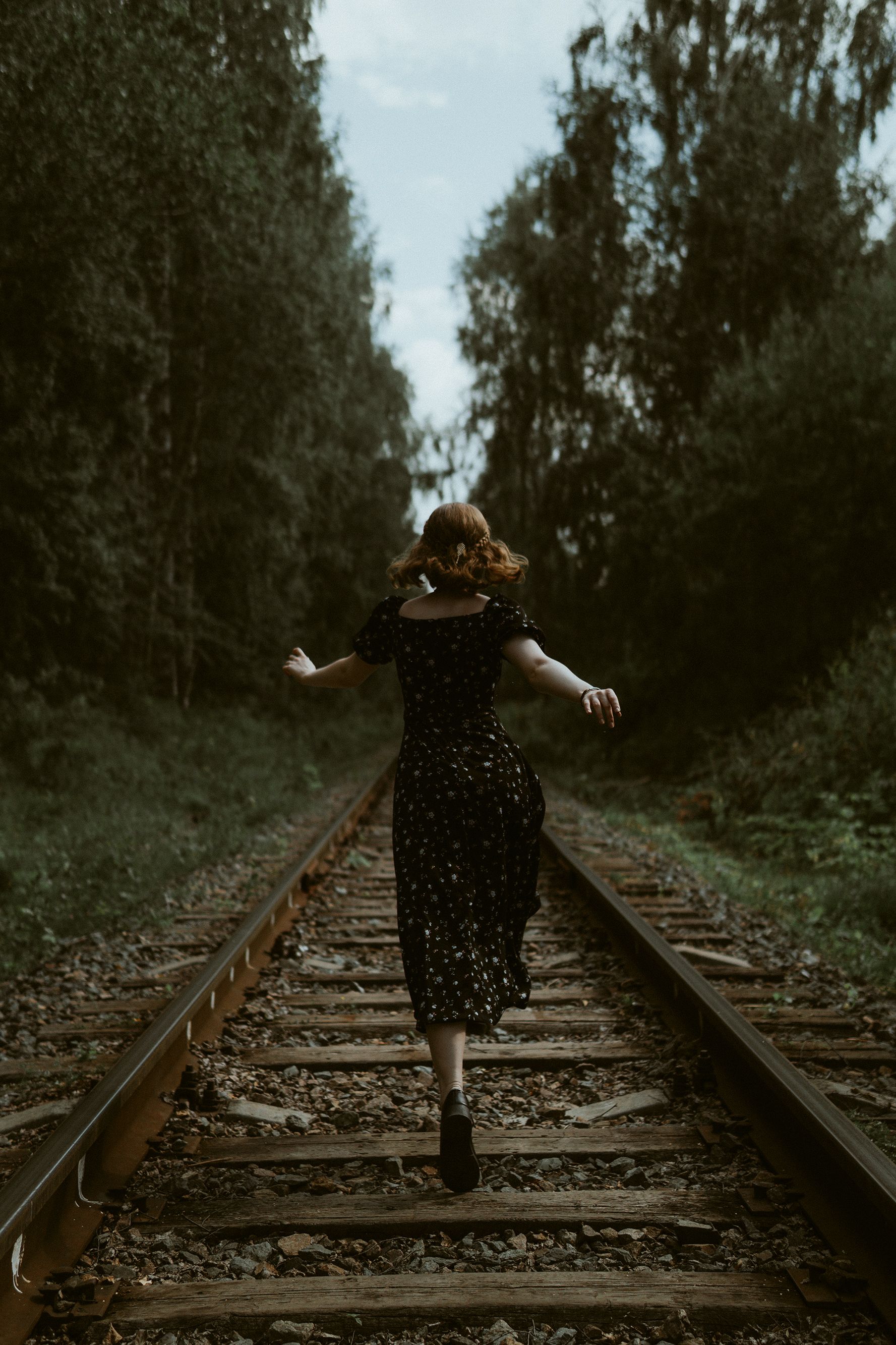 Girl in a Dress Standing on a Railway Track · Free Stock Photo
