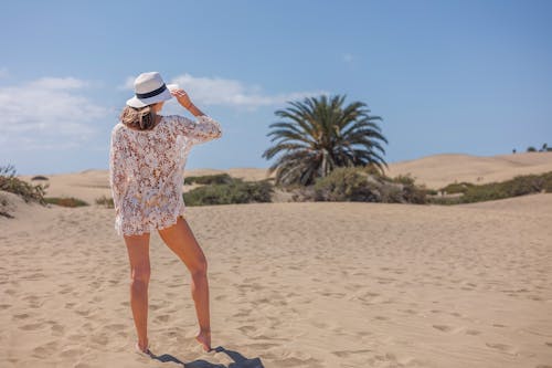 Woman in Hat Posing on Beach