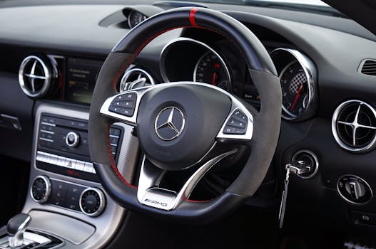 Detailed view of Mercedes-Benz steering wheel and dashboard with AMG branding.