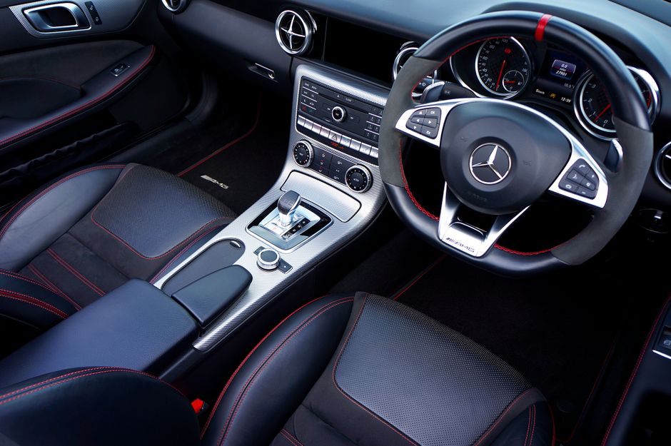 Explore the sleek design of a luxury vehicle interior featuring a modern dashboard and premium materials.