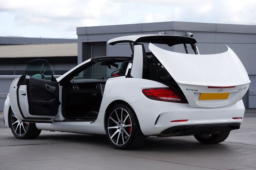 Elegant white convertible car with open roof showcasing luxury design and performance.