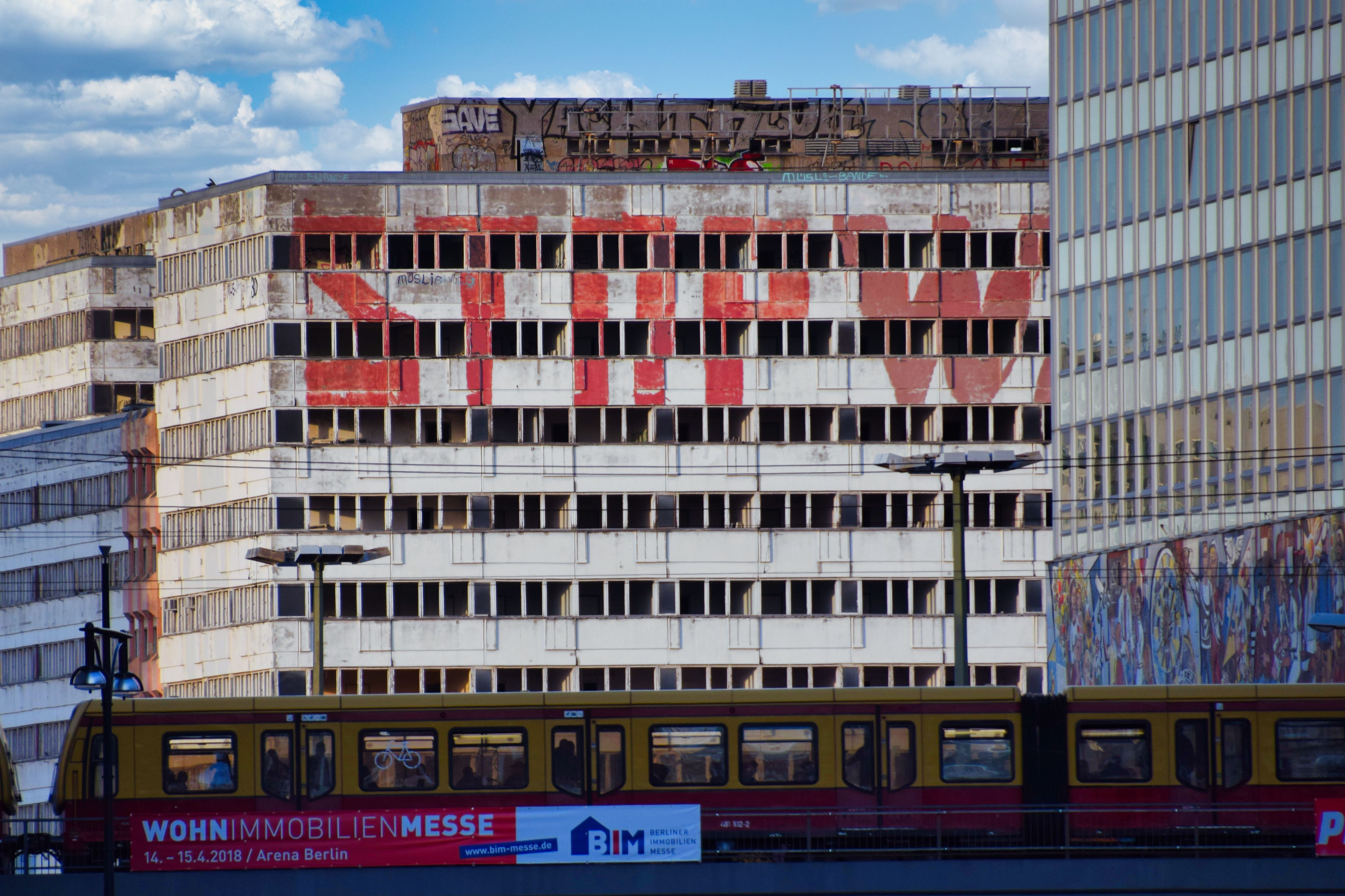 Captured view of Berlin's Haus der Statistik with tram and graffiti.