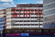 Captured view of Berlin's Haus der Statistik with tram and graffiti.