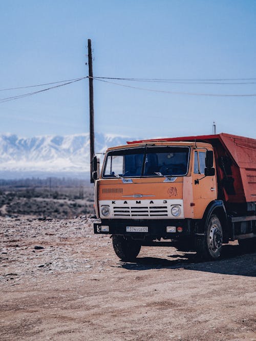 Безкоштовне стокове фото на тему «вантажівка, вертикальні постріл, ґрунтова дорога»