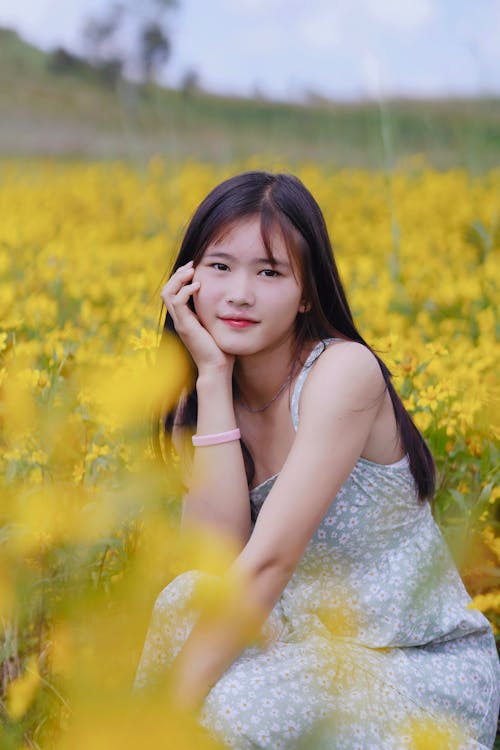 Woman in Dress among Flowers