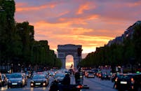 凯旋门上，生动的日落天空捕捉了巴黎的交通与建筑