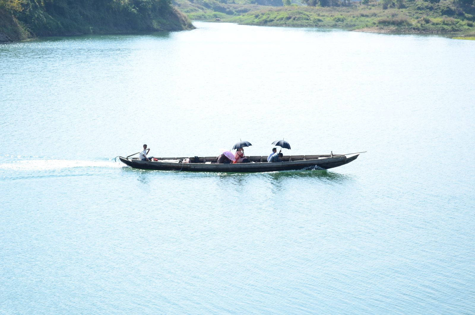 A group of people are riding in a boat on a river · Free Stock Photo