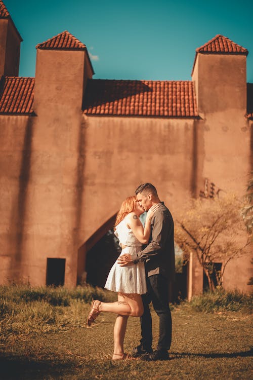 Free Young Couple Kissing in front of a Castle  Stock Photo