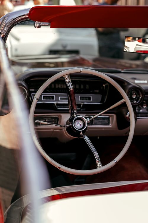 Free Close-up view of a vintage car's steering wheel and dashboard, showcasing classic design. Stock Photo