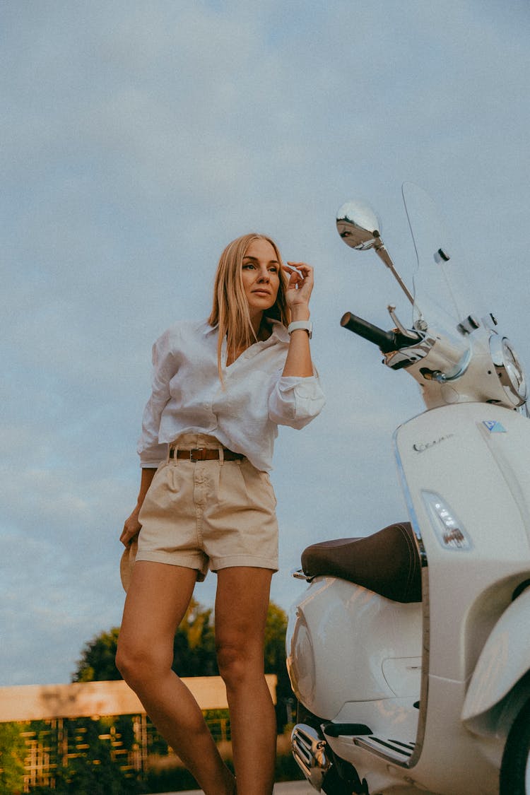 Blonde Woman Posing With Vespa