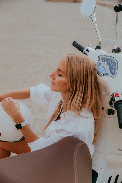 Blonde Woman Posing with Eyes Closed by Scooter