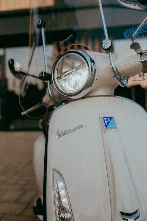 Free Detailed view of a white Vespa scooter showcasing its vintage design. Stock Photo