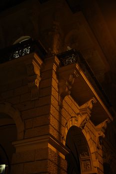 Stylish Viennese building facade captured beautifully under the night lights.
