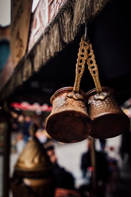 Free Elegant copper coffee pots hanging in a traditional market setting, capturing Turkish culture. Stock Photo
