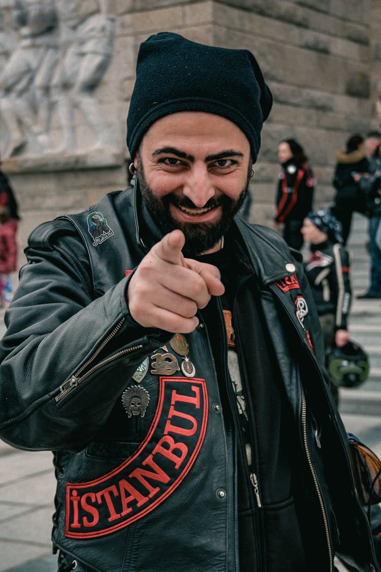 Bearded Biker In Leather Jacket Pointing At Camera