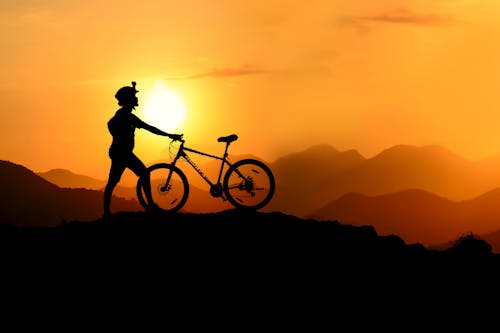 Δωρεάν στοκ φωτογραφιών με mountain bike, orange_background, Ανατολή ηλίου
