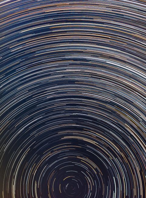 Long exposure photograph capturing star trails in the night sky of São Pedro de Alcântara, SC, Brazil.