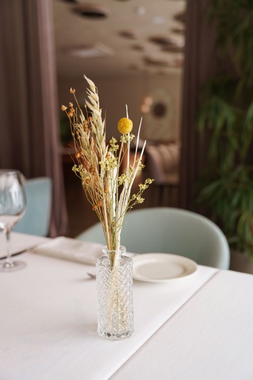 Free Beautiful dried flower arrangement in a vase on a restaurant table setting. Stock Photo