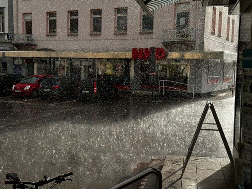 Free Rain falls on a city street in Bad Säckingen, Germany, showing urban life and weather. Stock Photo