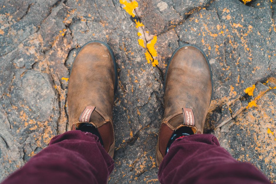 Weathered leather boots on cracked stone: the heritage silhouette Blundstone built its name on.