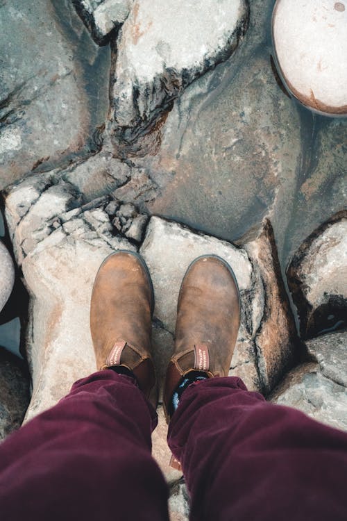 Person Brown Leather Boots Standing on Dry Rock