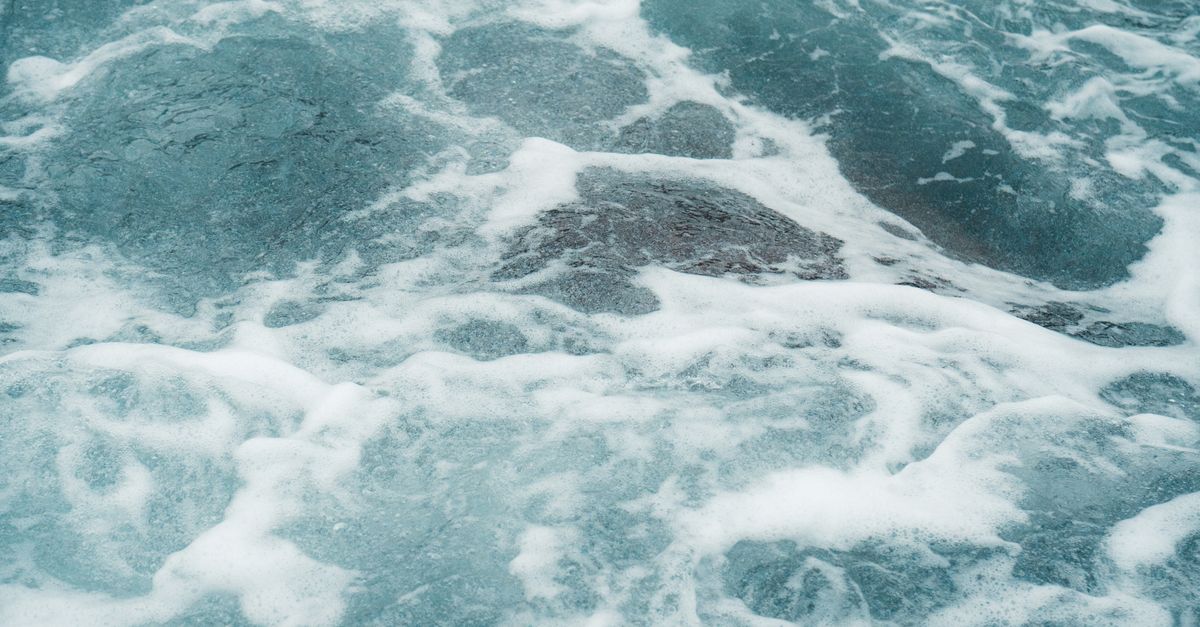 Striring Water Foam Forming on Surface of Stirring Water on Shore · Free Stock Photo