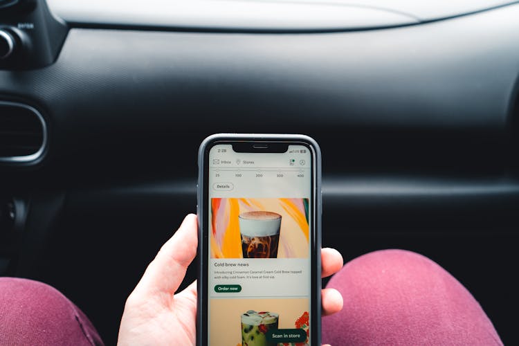 Hand Holding Cellphone In Car