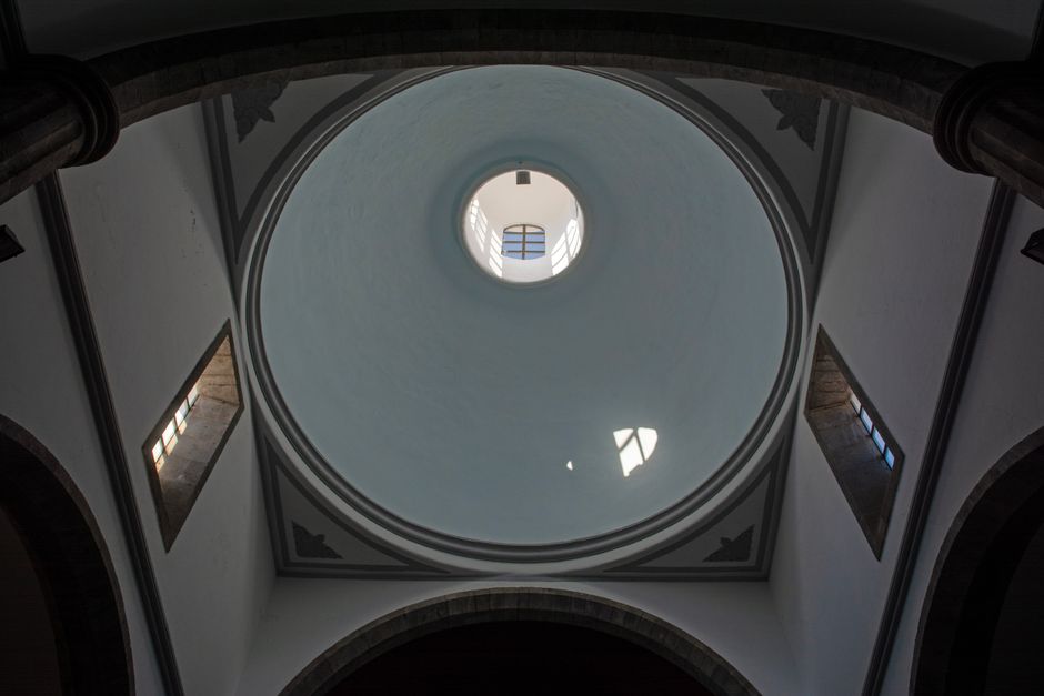 Low-angle view of a majestic dome interior in a church, showcasing architectural elegance.