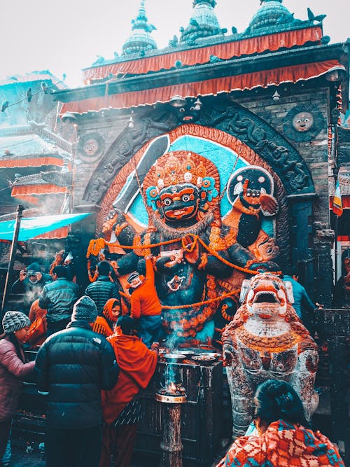 People Praying in front of a Hindu Deity