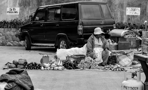 Grayscale Photography Of Person Selling On The Streets