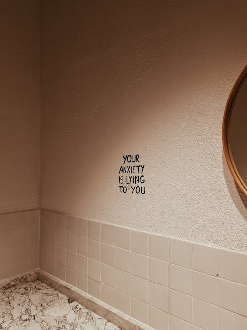 Text About Anxiety Problems on White Wall in Bathroom
