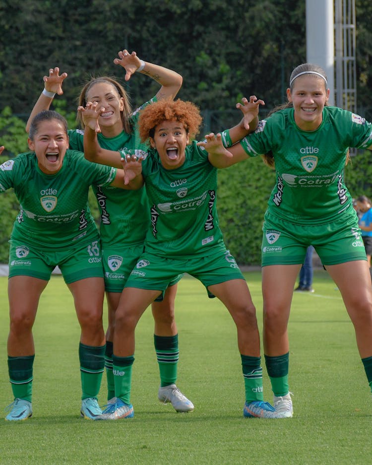 A Group Of Female Soccer Players Cheering After The Match 