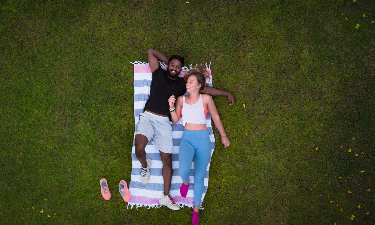 Free Woman and Man Lying on Rug Stock Photo