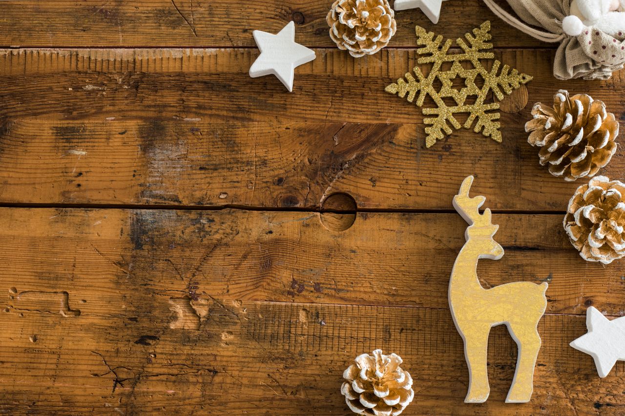 a vintage flatlay of christmas decorations on rustic wooden planks per