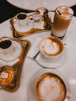 Cozy café scene with espresso and coffee cups served on elegant trays.