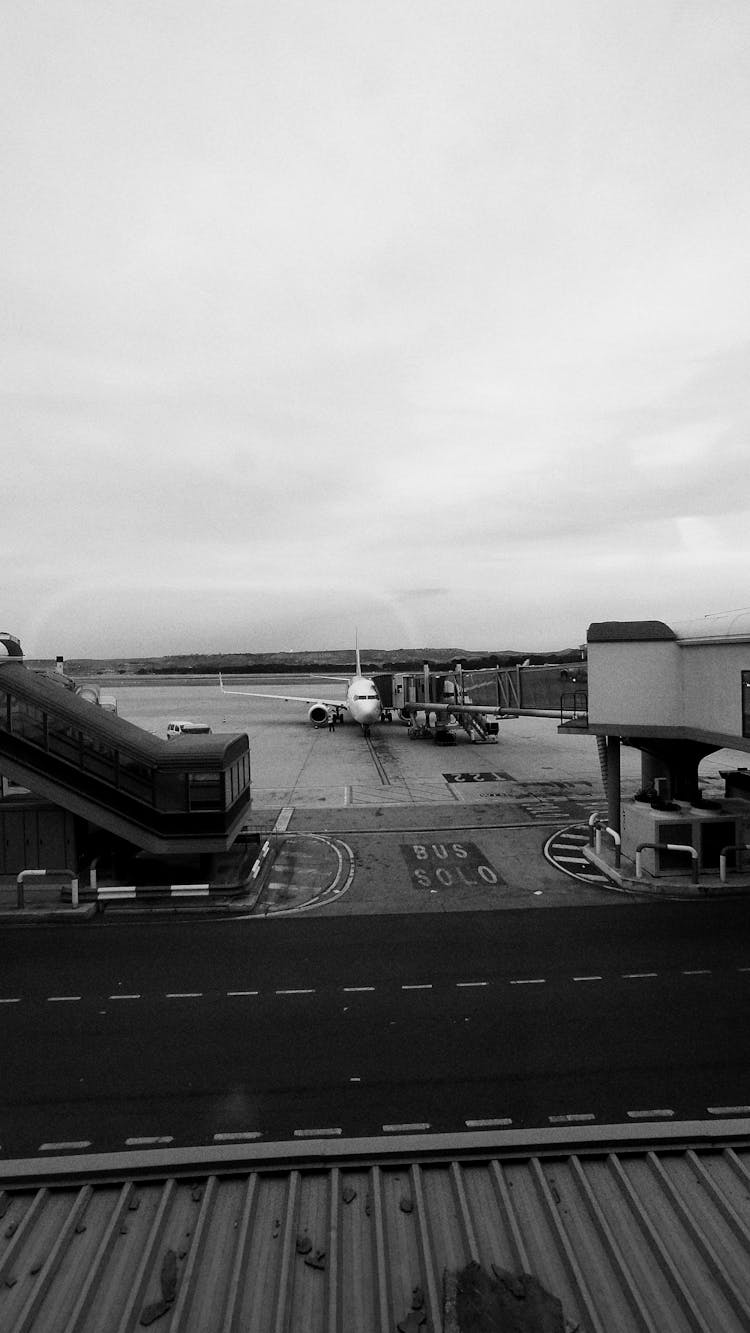 Clouds Over Airplane On Tarmac