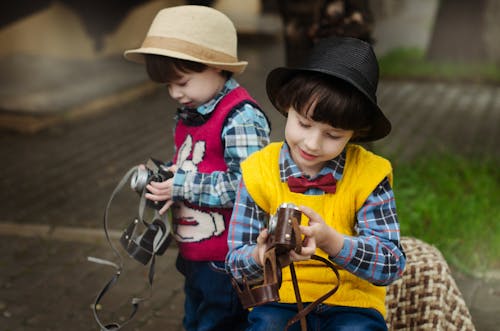 Two Boys Holding Camera