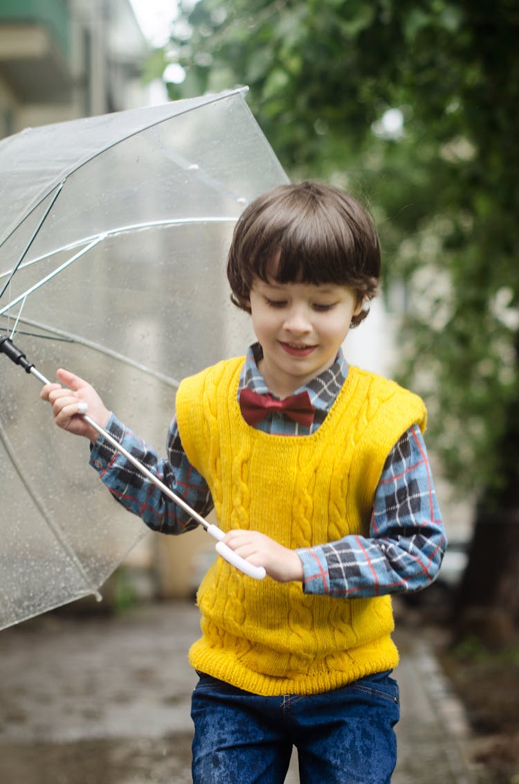 Kid Carrying Clear Umbrella