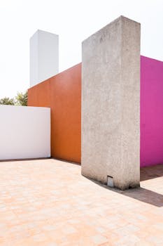 Vibrant colored walls forming an abstract geometric outdoor setting.