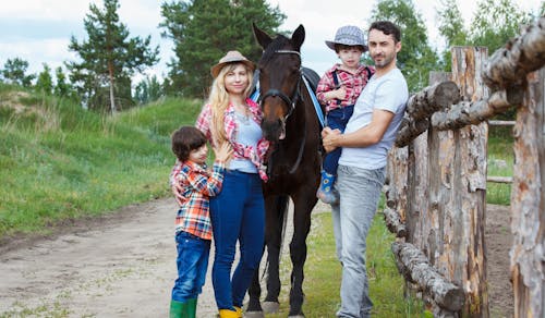Free Family Standing Beside Horse Stock Photo