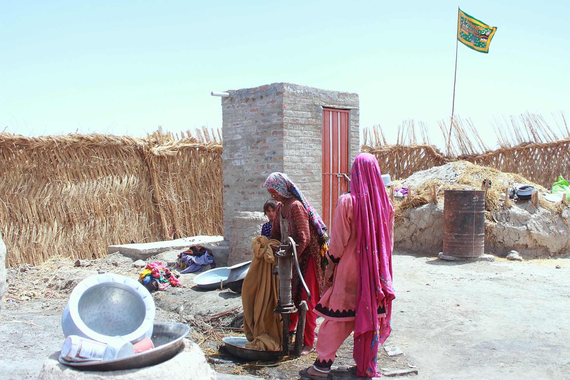 Women gather by a water pump in a rural village in Shikarpur, Pakistan.