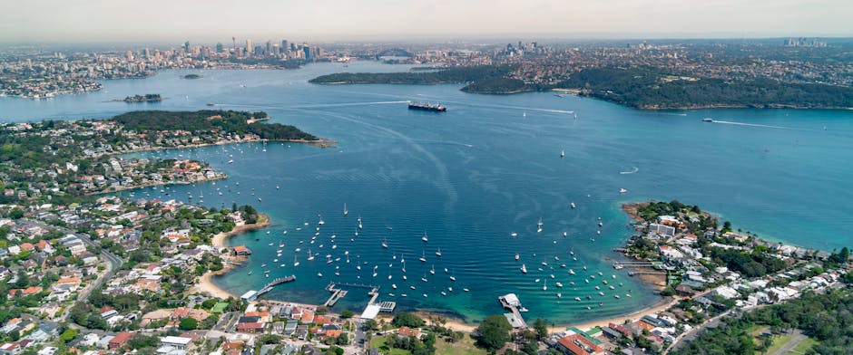 Stunning aerial view of Sydney Harbour, cityscape, and coastal area.