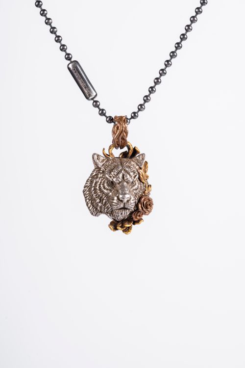 Free Intricately designed tiger head pendant necklace on a simple chain, ideal for fashion enthusiasts. Stock Photo