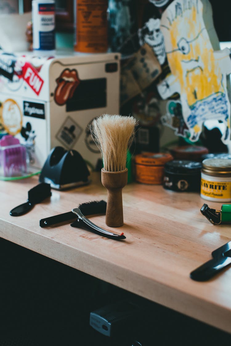 Brushes On Desk With Stickers And Drawings